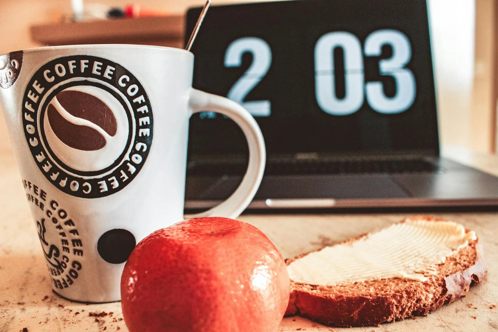 Morning coffee, pastry and laptop on a desk — the stereotypical first meal of the day